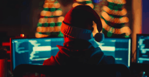 Holiday Risk Report: Hacker wearing a Santa hat representing cybercrime spikes in December